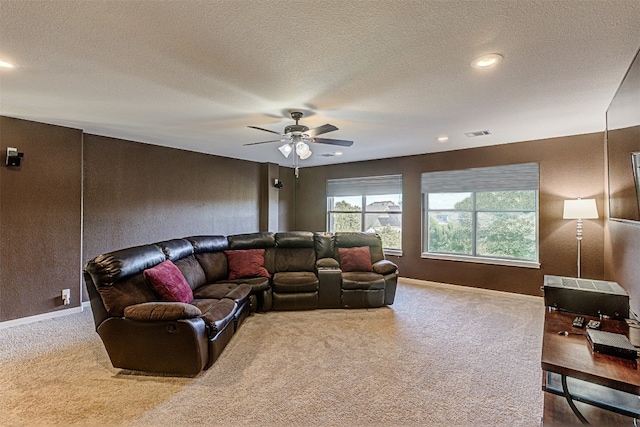 living room with ceiling fan, carpet, and a textured ceiling