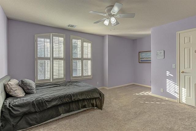 bedroom with a ceiling fan, carpet flooring, baseboards, and visible vents