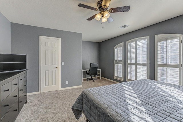 carpeted bedroom featuring visible vents, a ceiling fan, and baseboards