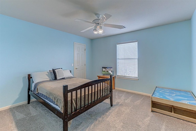 carpeted bedroom with ceiling fan and baseboards