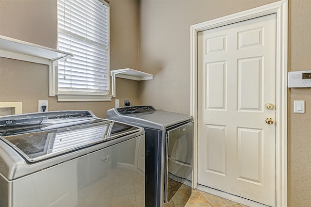 clothes washing area featuring separate washer and dryer