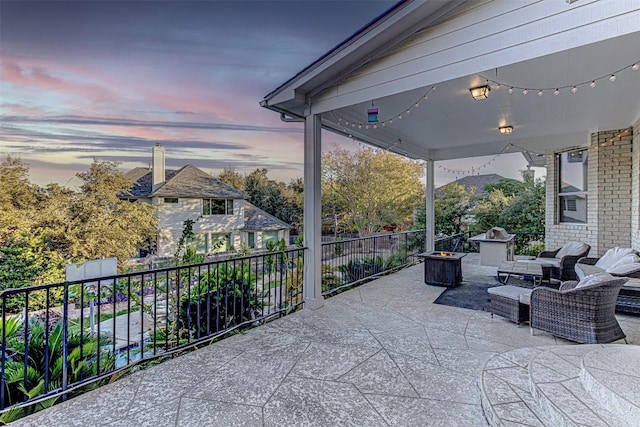 patio terrace at dusk with a fire pit