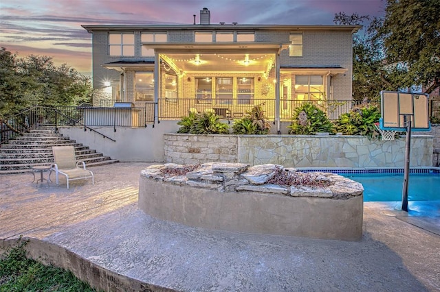 view of patio with a fenced in pool and stairs