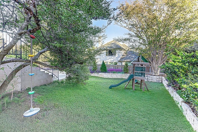 view of yard with a playground and fence