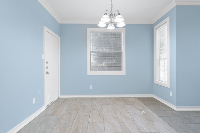 spare room with ornamental molding and a chandelier