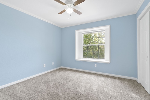 empty room with crown molding, carpet flooring, and ceiling fan