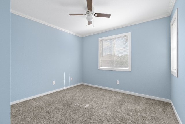 carpeted empty room featuring crown molding and ceiling fan