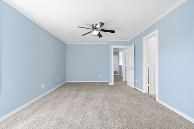 spare room with crown molding, light colored carpet, and ceiling fan