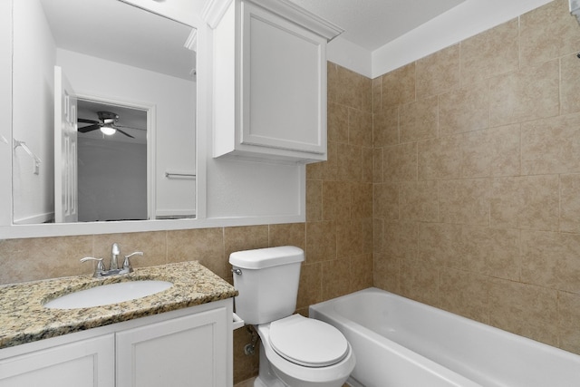 full bathroom with tasteful backsplash, toilet, tile walls, tiled shower / bath, and vanity