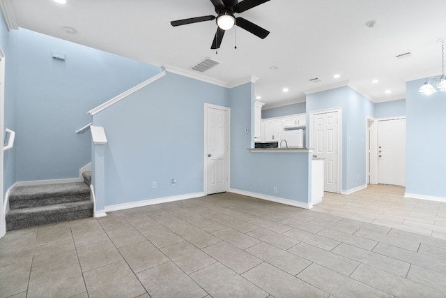 unfurnished living room featuring crown molding, light tile patterned flooring, and ceiling fan