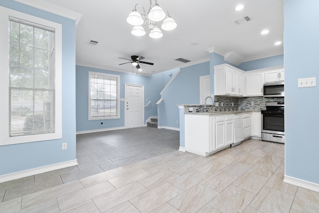 kitchen featuring crown molding, white cabinets, stainless steel appliances, and ceiling fan with notable chandelier