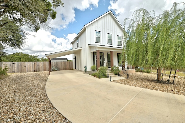 modern farmhouse style home featuring covered porch and a carport