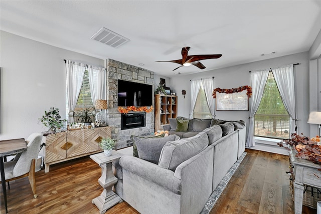 living room with a fireplace, hardwood / wood-style floors, a wealth of natural light, and ceiling fan