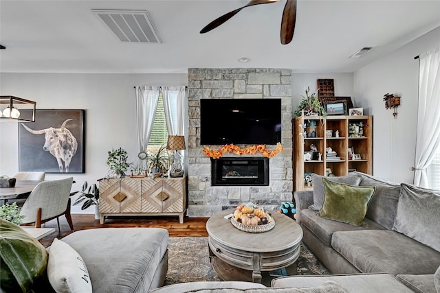 living room with a fireplace and hardwood / wood-style flooring