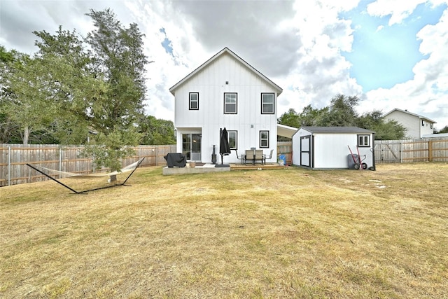 rear view of house with a yard and a shed