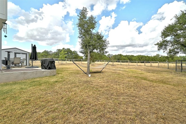 view of yard with a rural view and a patio