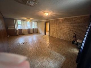 4906 Westfield Dr, Austin, TX 78731 - unfurnished room with brick wall