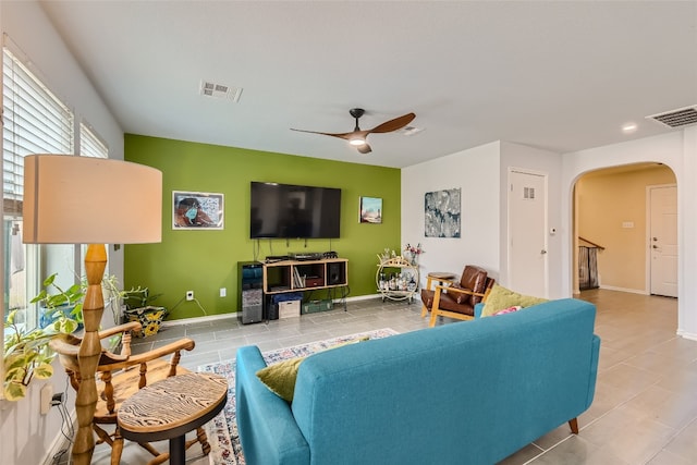 living room with ceiling fan and light tile patterned flooring