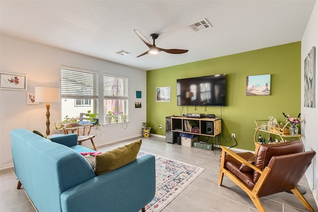 tiled living room with ceiling fan