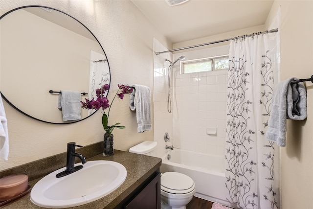 full bathroom featuring shower / bath combo with shower curtain, vanity, and toilet