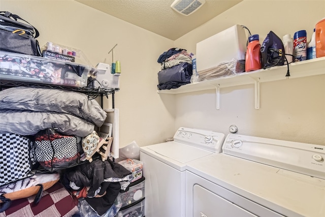 washroom featuring washer and dryer and a textured ceiling