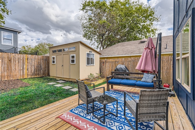 wooden deck with an outdoor living space, a yard, and a shed