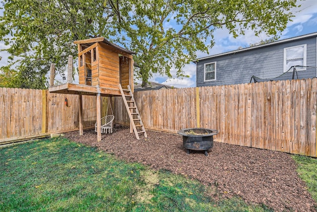 view of yard with a fire pit