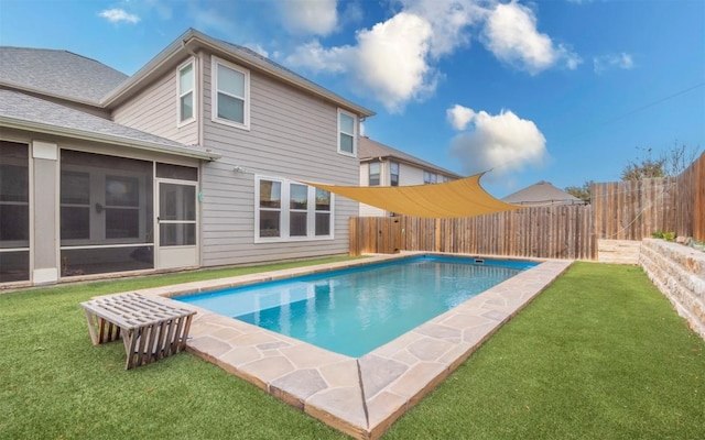 view of pool featuring a sunroom and a yard