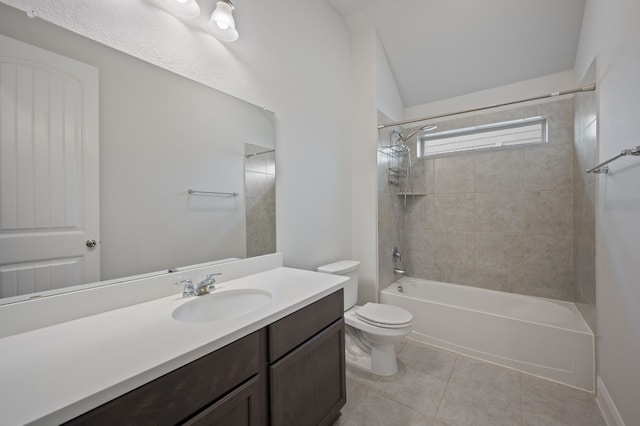 full bathroom featuring toilet, vaulted ceiling, vanity, tiled shower / bath combo, and tile patterned flooring