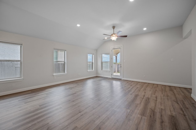 empty room with light hardwood / wood-style floors, ceiling fan, and vaulted ceiling