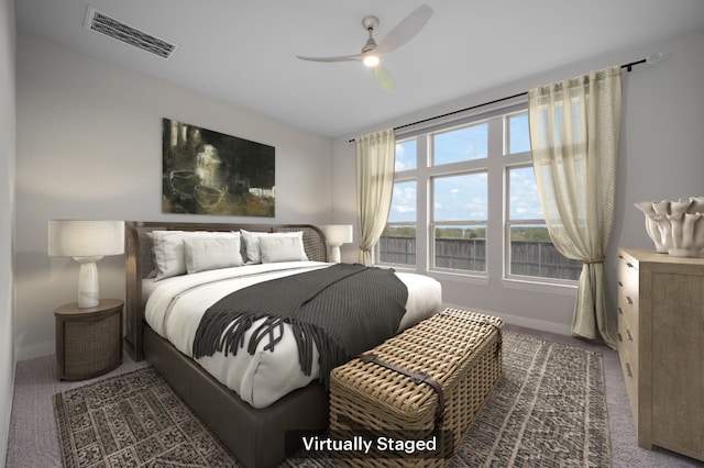 bedroom featuring ceiling fan and dark colored carpet