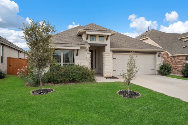 view of front of property featuring a front yard and a garage