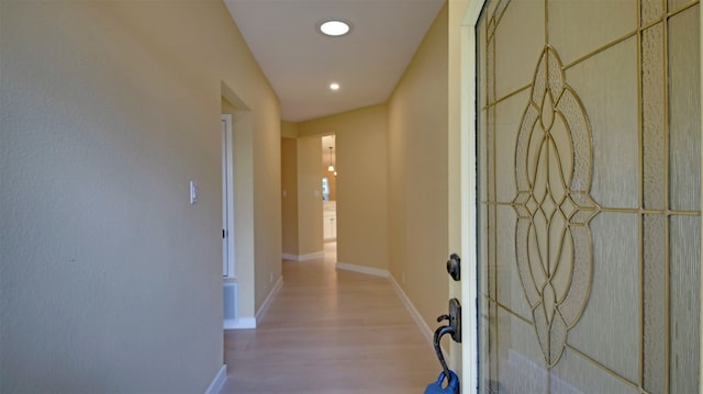 corridor with light wood-type flooring