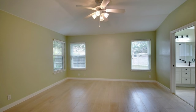 unfurnished room with ceiling fan, plenty of natural light, and light wood-type flooring