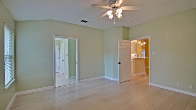 unfurnished room with ceiling fan, sink, light hardwood / wood-style floors, and lofted ceiling