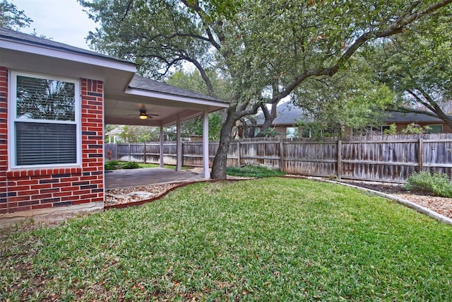 view of yard featuring ceiling fan and a patio