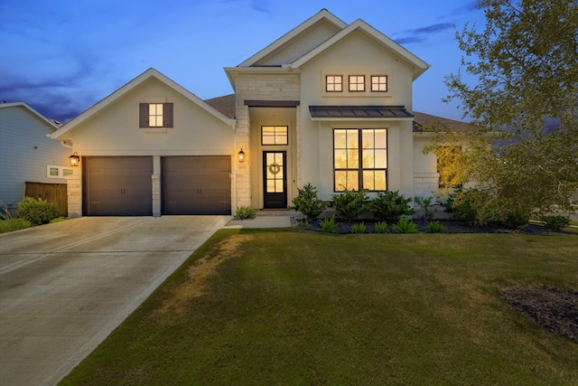 view of front of house featuring a yard and a garage