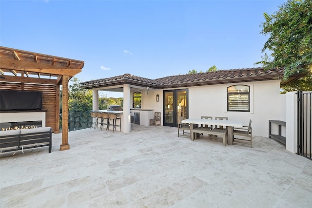 view of patio / terrace with a bar and a pergola