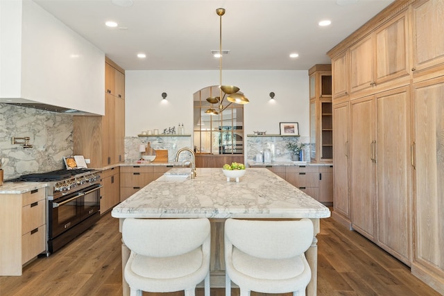 kitchen with tasteful backsplash, light brown cabinetry, dark hardwood / wood-style flooring, and double oven range