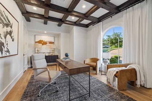 office with beam ceiling, coffered ceiling, and light hardwood / wood-style flooring