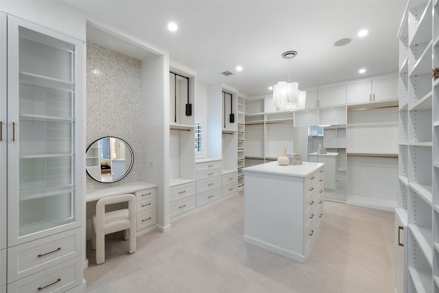 spacious closet featuring a notable chandelier