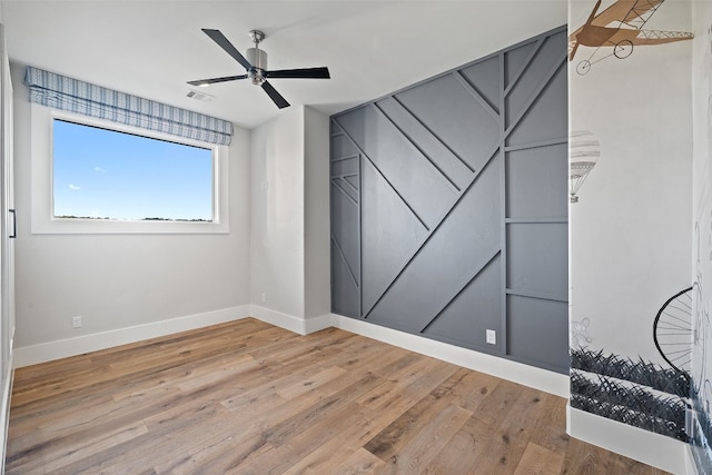 spare room with ceiling fan and light hardwood / wood-style flooring