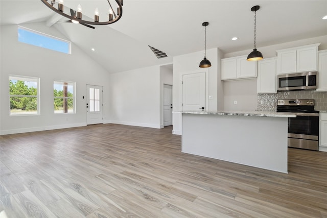 kitchen featuring appliances with stainless steel finishes, light hardwood / wood-style flooring, and white cabinetry