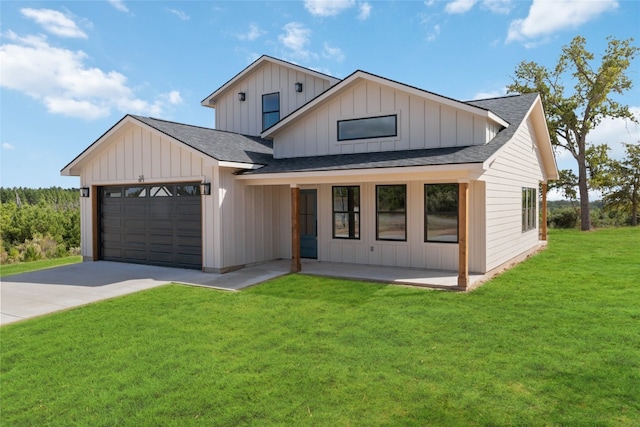 modern farmhouse featuring a front lawn and a garage