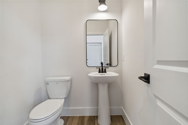 bathroom featuring toilet and hardwood / wood-style flooring