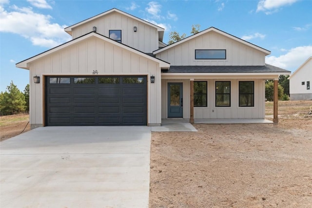 343 Cottle Town Rd Unit A, Smithville, TX 78957 - modern farmhouse with concrete driveway, a garage, board and batten siding, and a shingled roof