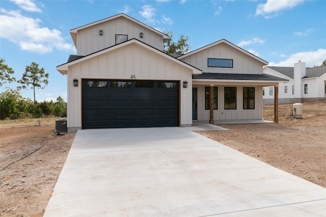 modern inspired farmhouse featuring covered porch and a garage