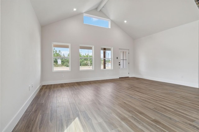343 Cottle Town Rd Unit A, Smithville, TX 78957 - unfurnished living room featuring beamed ceiling, wood finished floors, high vaulted ceiling, and recessed lighting