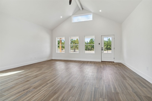 unfurnished living room with hardwood / wood-style floors, beam ceiling, high vaulted ceiling, and ceiling fan