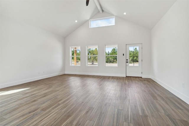 343 Cottle Town Rd Unit A, Smithville, TX 78957 - unfurnished living room featuring beam ceiling, wood finished floors, high vaulted ceiling, a ceiling fan, and healthy amount of natural light